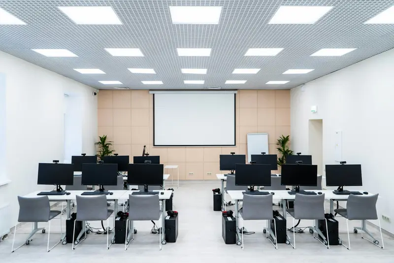 a room of desks with computers